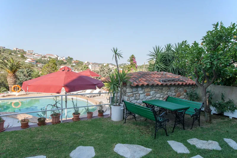 Garden tables on the lawn by the pool